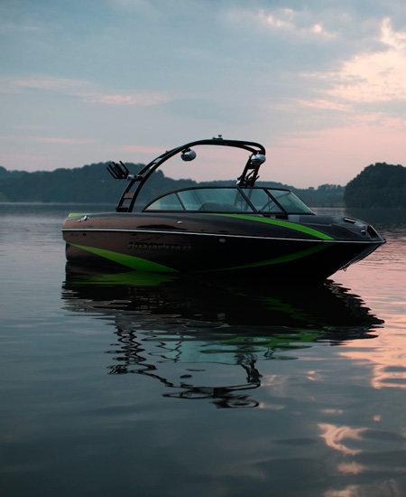 boat in the water with a sunset landscape